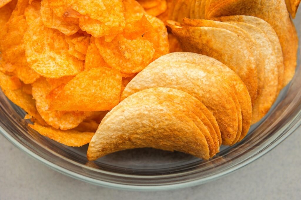 crisps, nibble, pringles, chipsets, savory biscuits, potato chips, salty, crispy, hearty, snack, snack food, meal, key, glass, glass bowl, yellow, crunch, crisps, pringles, potato chips, potato chips, potato chips, potato chips, potato chips